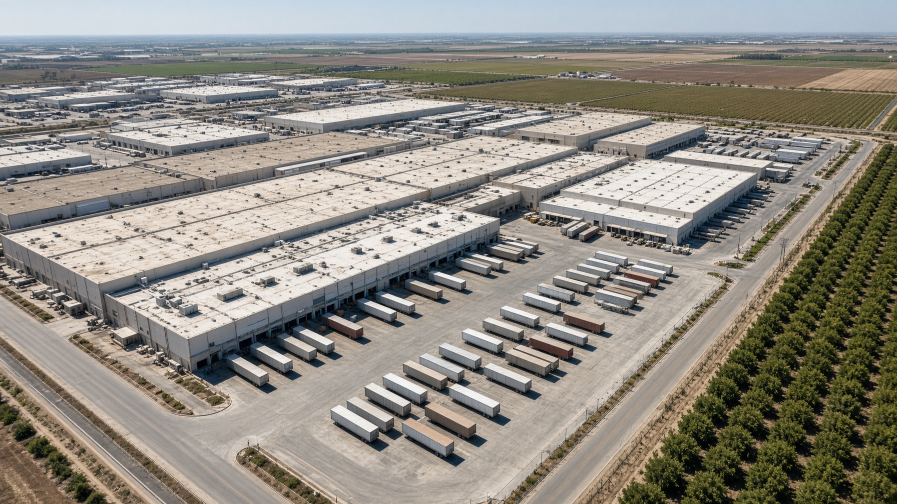 Reconstruction — Central Valley storage plant, orchards at the edge. Distinct from Energy’s Megapack still.