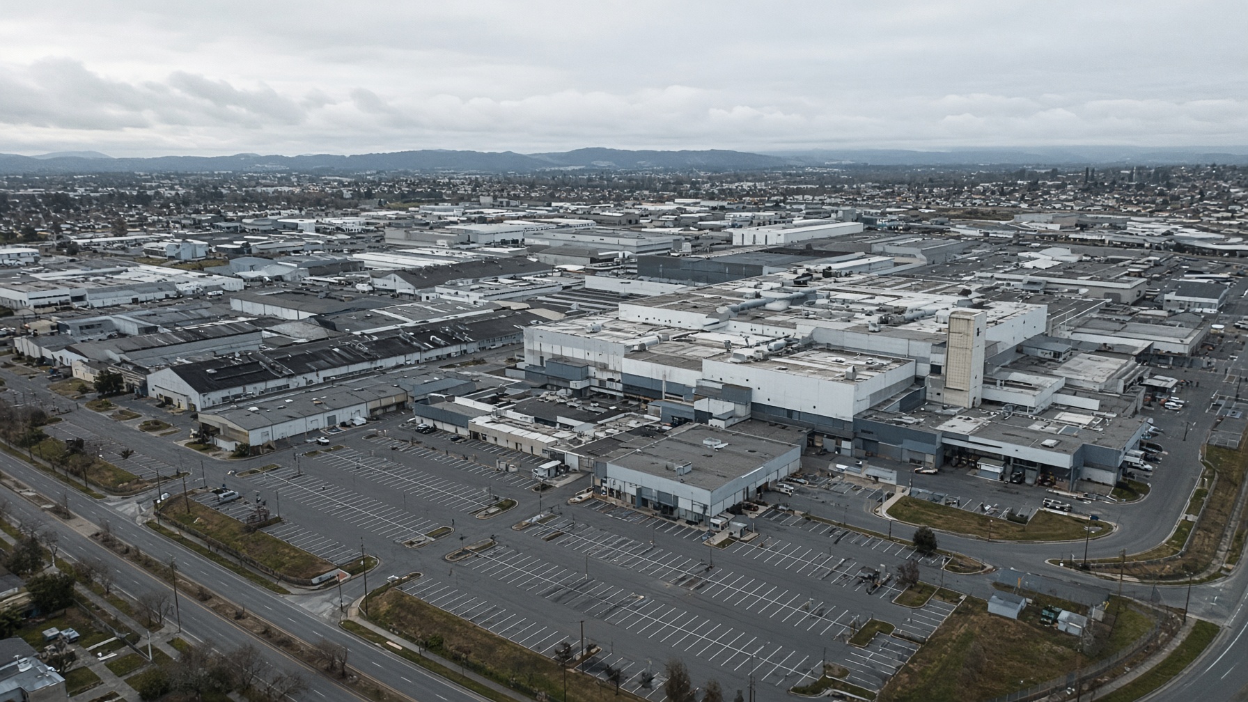 Reconstruction — California auto campus, overcast. Not a live webcam. Distinct from the Fremont still used on Optimus.